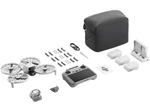 Charger l&#39;image dans la galerie, Kit de drone avec drone, télécommande, batteries, chargeur et accessoires, sur fond noir.
