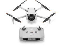 Charger l&#39;image dans la galerie, Un drone blanc avec quatre hélices et une télécommande sur fond blanc.
