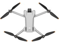 Drone gris, vue de dessus, avec quatre hélices noires et à bouts oranges. Le logo DJI est visible.