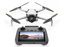 Charger l&#39;image dans la galerie, Drone et télécommande avec écran, drone blanc avec hélices grises.
