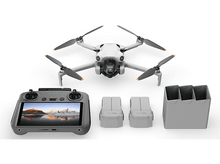 Charger l&#39;image dans la galerie, Un drone, une télécommande, des batteries et un étui de chargement sur fond blanc.
