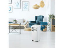 Charger l&#39;image dans la galerie, Un climatiseur portable blanc se trouve dans un salon avec des meubles et des œuvres d&#39;art.
