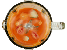 Charger l&#39;image dans la galerie, Vue de dessus d&#39;un mélangeur avec du liquide orange, et des tomates et concombres coupés.
