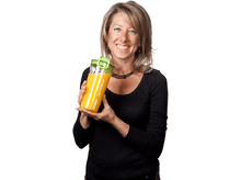 Charger l&#39;image dans la galerie, Une femme tenant une bouteille de jus jaune avec un bouchon vert et souriant. Fond blanc.
