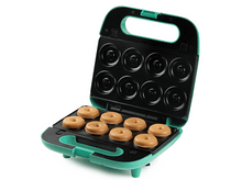 Charger l'image dans la galerie, Machine à donuts turquoise ouverte avec huit donuts à l'intérieur sur fond blanc.
