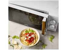 Charger l&#39;image dans la galerie, Un micro-ondes avec des pâtes. La porte est ouverte, montrant un bol de pâtes à la sauce et au basilic.
