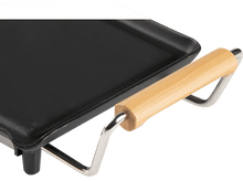 Charger l&#39;image dans la galerie, Une plaque de cuisson noire avec une poignée en bois. La poignée est métallique avec une prise en bois.
