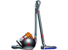 Charger l&#39;image dans la galerie, Aspirateur Dyson, argent et rouge. Corps arrondi, longue poignée et tuyau. Fond noir.
