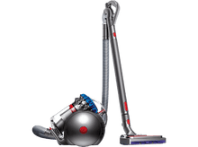 Charger l&#39;image dans la galerie, Un aspirateur Dyson sur fond noir. Il a une palette de couleurs argent et rouge.
