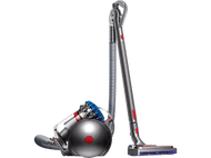 Un aspirateur Dyson sur fond noir. Il a une palette de couleurs argent et rouge.