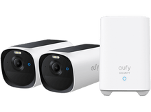 Charger l&#39;image dans la galerie, Deux caméras de sécurité blanches, lentilles noires, et une station de base blanche.
