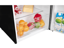 Charger l&#39;image dans la galerie, Réfrigérateur ouvert avec fruits, poivrons et fromage. Bouteilles et cartons de lait sur la porte.
