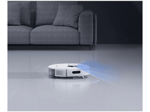 Charger l&#39;image dans la galerie, Aspirateur robot blanc sur un sol. Canapé gris en arrière-plan.
