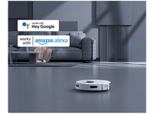 Charger l&#39;image dans la galerie, Un aspirateur robot blanc sur un sol gris avec les logos Hey Google et Amazon Alexa.
