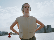 Charger l&#39;image dans la galerie, Une femme portant un casque devant un plan d&#39;eau.
