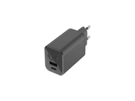 Un chargeur USB gris foncé avec deux ports et deux broches métalliques pour une prise européenne, sur fond noir.