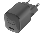 Un chargeur de téléphone noir avec deux broches et un port de charge, sur fond noir.