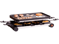 Grill à raclette avec fromage et nourriture. Viande et légumes dessus, fromage dessous.