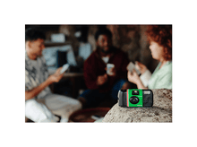 Charger l&#39;image dans la galerie, Appareil photo QuickSnap sur un rocher avec trois personnes en arrière-plan flou.
