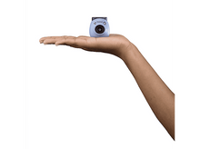 Charger l&#39;image dans la galerie, La main d&#39;une personne tenant un petit appareil photo Instax bleu clair, sur fond blanc.

