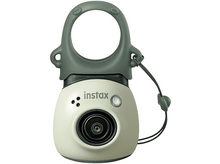 Charger l&#39;image dans la galerie, Un petit appareil photo instax vert clair avec une poignée de transport et un objectif.
