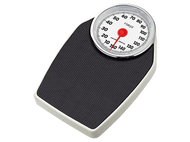 Une balance avec une surface noire et une bordure blanche. Le cadran affiche une aiguille rouge à 140 lbs.