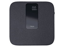 Balance numérique avec affichage numérique indiquant 0,0 kg. Tissu gris avec le logo Haepi.