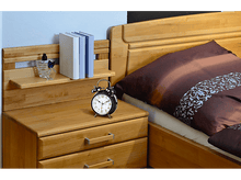 Charger l&#39;image dans la galerie, Une scène de chambre avec une table de chevet et un lit en bois. Une horloge et des livres.
