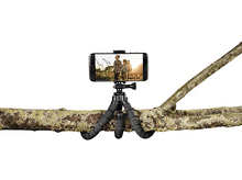 Charger l&#39;image dans la galerie, Un smartphone sur un trépied sur une branche. Le téléphone affiche une photo de personnes dans la nature.
