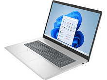 Charger l&#39;image dans la galerie, Un ordinateur portable argenté est ouvert, affichant l&#39;interface Windows 11. L&#39;écran montre des icônes d&#39;applications. Le clavier est visible, et l&#39;ordinateur est sur une surface blanche.
