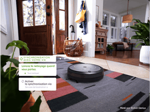 Charger l&#39;image dans la galerie, Un aspirateur robot sur un tapis avec du texte en français sur la synchronisation.
