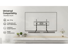 Charger l&#39;image dans la galerie, Un téléviseur est monté au mur au-dessus d&#39;une étagère blanche avec des plantes.
