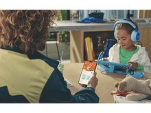 Charger l&#39;image dans la galerie, Une personne utilisant un téléphone montrant des écouteurs, avec une fille portant des écouteurs bleus.
