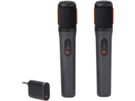 Deux microphones JBL noirs avec des accents orange et une station de charge.