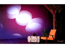 Charger l&#39;image dans la galerie, Scène avec un mur de briques et des projecteurs créant des cercles de lumière. Une chaise orange à droite.
