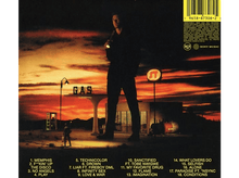 Charger l'image dans la galerie, Pochette d'album avec un homme devant une station-service au coucher du soleil. Texte en bas.
