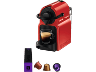 Machine Nespresso rouge avec une tasse de café. Capsules de café et une boîte en bas à gauche.