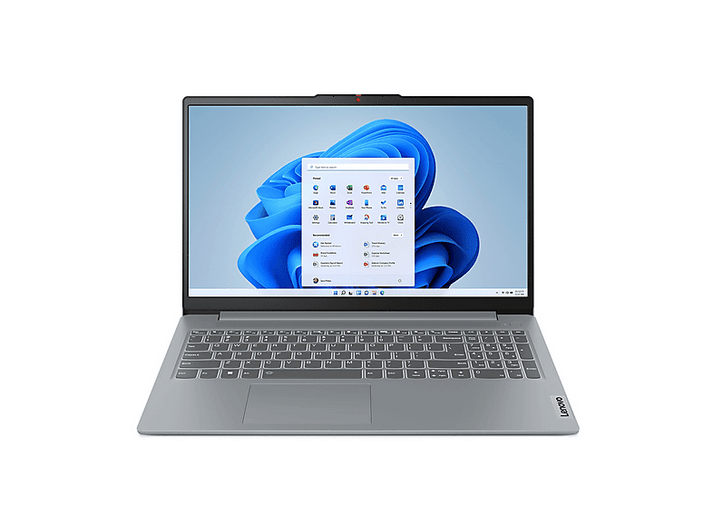 Un ordinateur portable Lenovo argenté est ouvert, affichant l'écran d'accueil de Windows 11. Le clavier est visible et l'écran affiche des icônes d'applications.