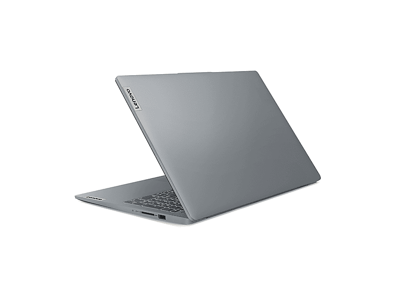 Un ordinateur portable Lenovo gris est légèrement ouvert. Le logo Lenovo est visible sur le couvercle. Le clavier et les ports sont également visibles.