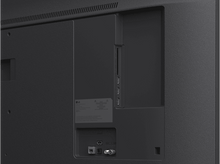 Charger l'image dans la galerie, Gros plan de l'arrière d'un téléviseur avec divers ports et connecteurs dans un environnement sombre.
