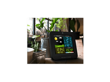 Charger l&#39;image dans la galerie, Station météo sur une table en bois avec des plantes près d&#39;une fenêtre. Affiche les informations météorologiques.
