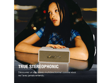 Charger l&#39;image dans la galerie, Femme regardant un haut-parleur Marshall, avec le texte &#39;TRUE STEREO&#39;.
