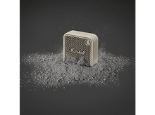 Charger l&#39;image dans la galerie, Petit haut-parleur Marshall beige sur un tas de poudre grise. Fond gris foncé.
