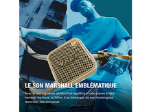 Charger l&#39;image dans la galerie, Un homme à vélo tient un haut-parleur Marshall doré. L&#39;arrière-plan est une ville floue.
