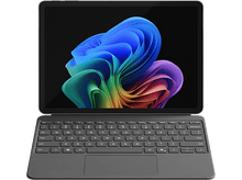 Charger l&#39;image dans la galerie, Une tablette avec clavier. L&#39;écran affiche un design abstrait coloré. Le clavier est gris foncé.
