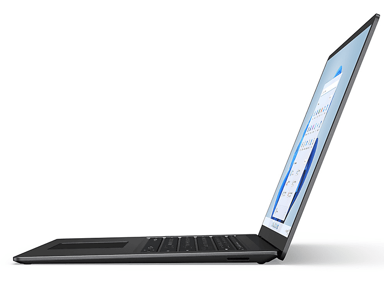 Un ordinateur portable argenté est légèrement ouvert. L'écran affiche une interface Windows. Le clavier et le pavé tactile sont visibles.