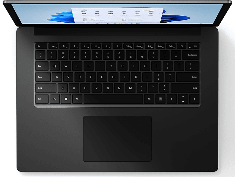 Vue de dessus d'un ordinateur portable noir, clavier au point, écran ouvert affichant une page web. L'écran a un fond bleu et blanc.
