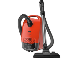 Aspirateur Miele rouge avec tuyau et accessoires noirs, sur fond noir.