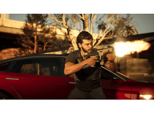 Charger l&#39;image dans la galerie, Un homme tirant avec une arme près d&#39;une voiture rouge, avec un éclair de bouche visible.
