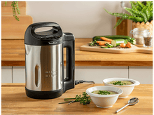 Charger l&#39;image dans la galerie, Soupière en acier inoxydable avec poignée. Deux bols de soupe et légumes sur table en bois.
